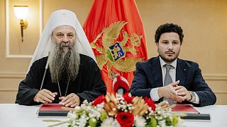 Serbian Orthodox Church Patriarch Porfirije and Montenegrin PM Dritan Abazović sign the property contract in Podgorica, 3 August 2022