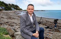 New Zealand Climate Change Minister James Shaw poses for a photo at Owhiro Bay beach in Wellington, New Zealand, Wednesday, Aug. 3, 2022.