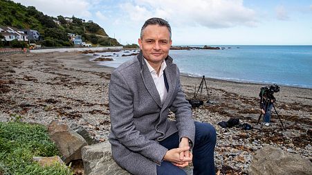New Zealand Climate Change Minister James Shaw poses for a photo at Owhiro Bay beach in Wellington, New Zealand, Wednesday, Aug. 3, 2022.