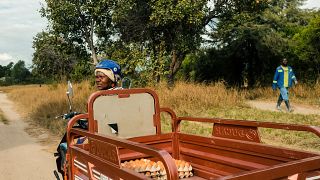 Danai heads to market on her solar-powered tricycle