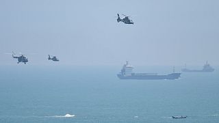 Chinese military helicopters fly past Pingtan island, one of mainland China's closest point from Taiwan, in Fujian province on August 4, 2022