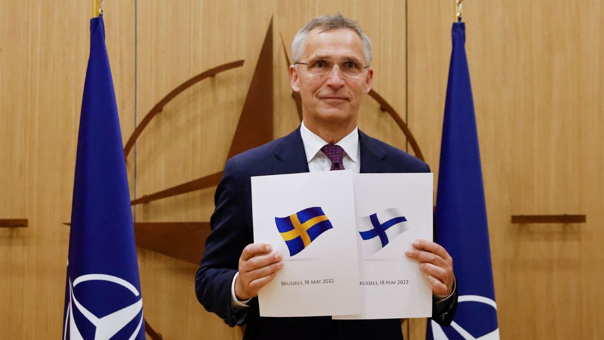 NATO Secretary-General Jens Stoltenberg displays documents as Sweden and Finland applied for membership in Brussels, Belgium, May 18, 2022.
