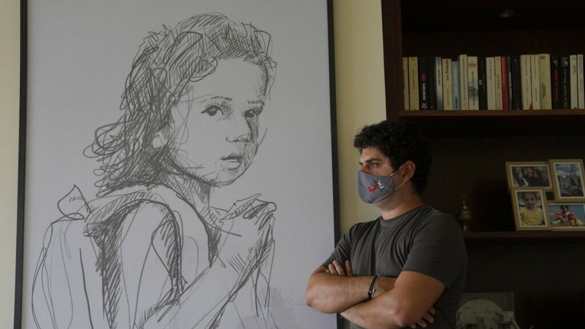 Paul Naggear, stands next a portrait of his daughter Alexandra, who was killed in 2020 massive blast at Beirut's seaport