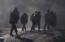 Ethnic Armenian soldiers walk along the road near the border between Nagorno-Karabakh and Armenia, Nov. 8, 2020.