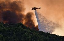 A firefighting helicopter throws water near the village of Krestena south of Ancient Olympia, southwest of Athens,  July 24, 2022.