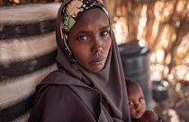 Asha, 32, holds her daughter Zeinab, who suffers from malnutrition, near their home in Garissa County, Kenya.