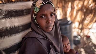 Asha, 32, holds her daughter Zeinab, who suffers from malnutrition, near their home in Garissa County, Kenya.