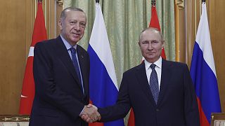 Turkish President Recep Tayyip Erdogan, left, and Russian President Vladimir Putin shake hands prior to their meeting in Sochi, 5 August 2022