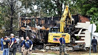 Feuerwehrleute stehen vor deer ausgebrannten Hausruine in Nescopeck (Pennsylvania)