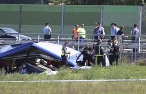 Rescuers remove a body from the wreckage of a bus at the crash scene in Podvorec, near Zagreb, Croatia, Saturday, Aug. 6, 2022.
