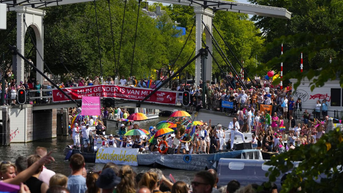 Hundreds of thousands of people lined canals in the Dutch capital to watch the colorful spectacle of the Pride