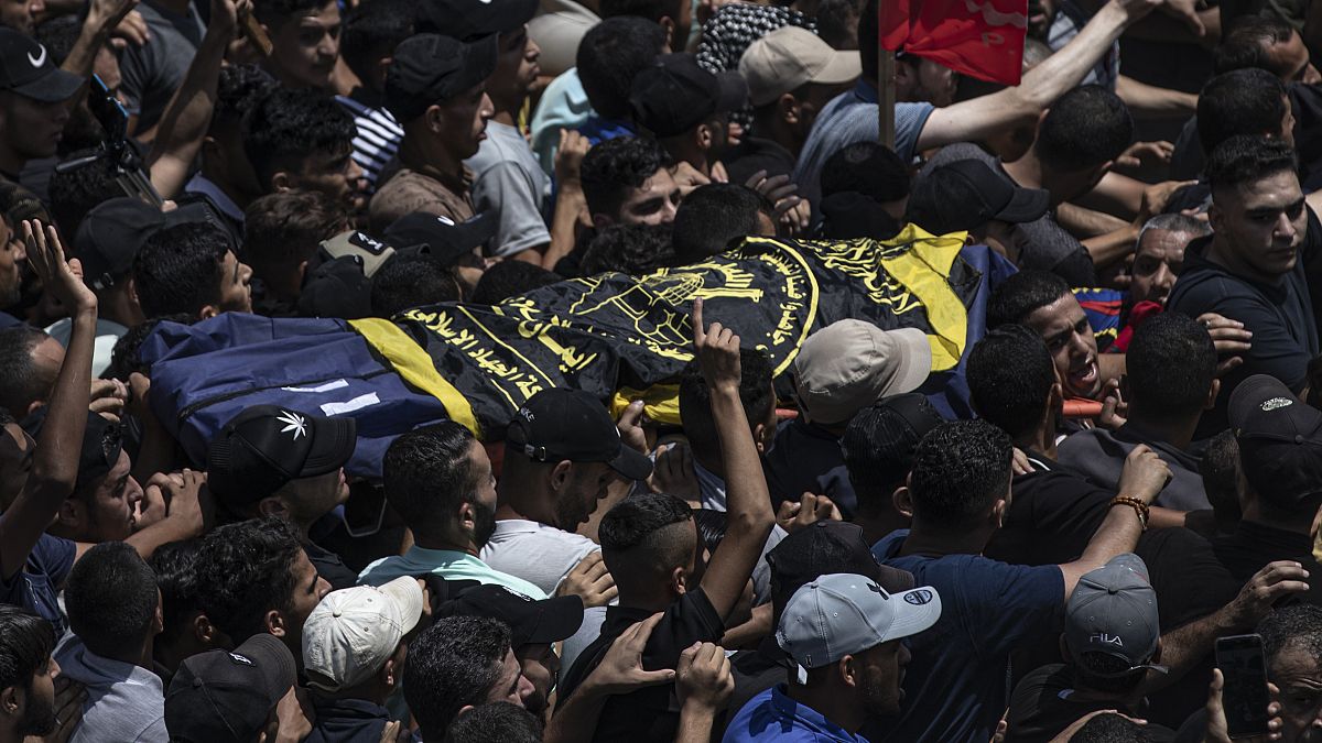 Mourners carry the body of Islamic Jihad commander Khaled Mansour during a funeral for him and others killed in Israeli airstrikes on Gaza, August 7, 2022.