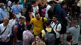 Train passengers wait at Atocha train station in Madrid, Spain, Monday, Aug. 8, 2022.