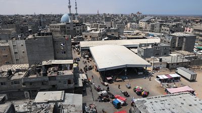 Palestinians shopping in Rafah town in the southern Gaza Strip, as a truce with Israel holds following three days of conflict.