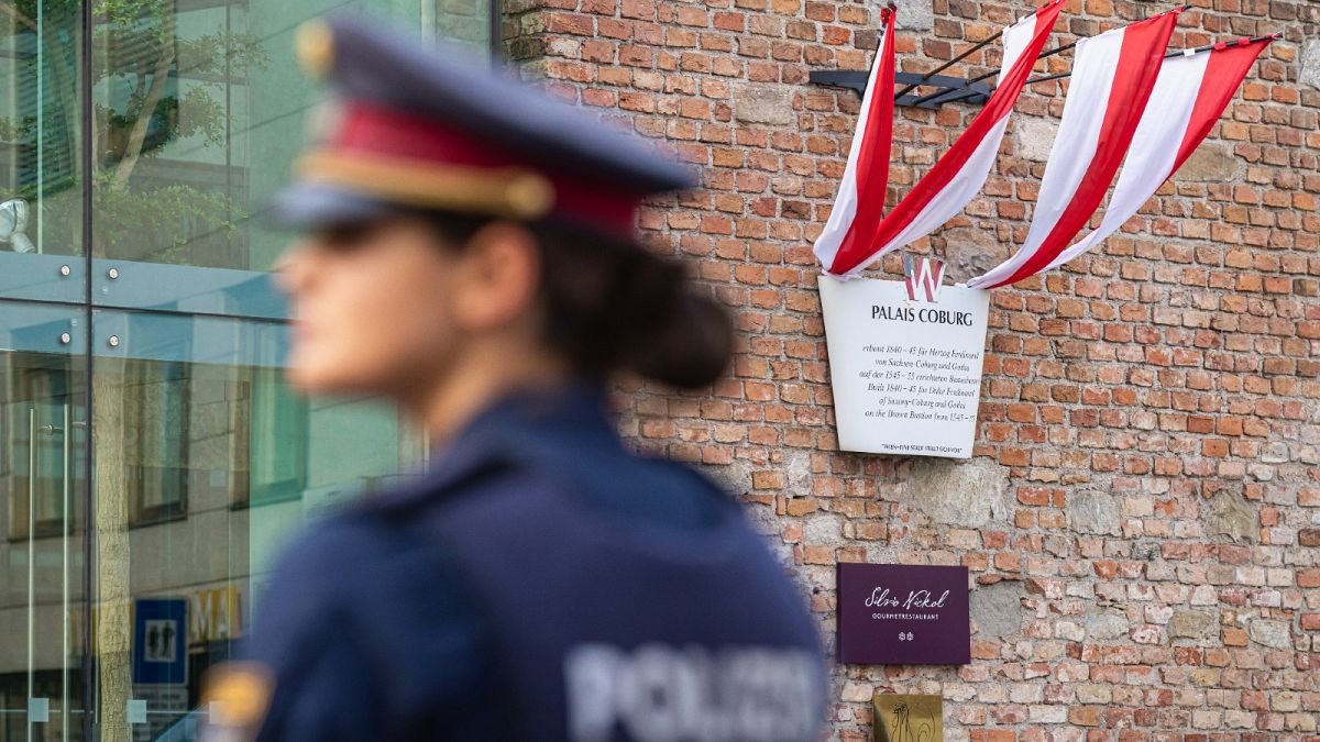 A police officer stands in front of the Palais Coburg where closed-door nuclear talks take place in Vienna, Austria, Aug. 5, 2022. 