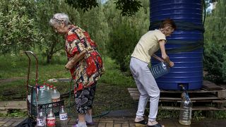 Residents fill up water bottles in a park near their apartments in Sloviansk, Donetsk region.
