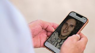 بول راولت والد سيباستيان راولت، يحمل هاتفياً ذكياً تظهر على شاشته صورة ابنه في إبينال، شرق فرنسا، 1 أغسطس 2022.