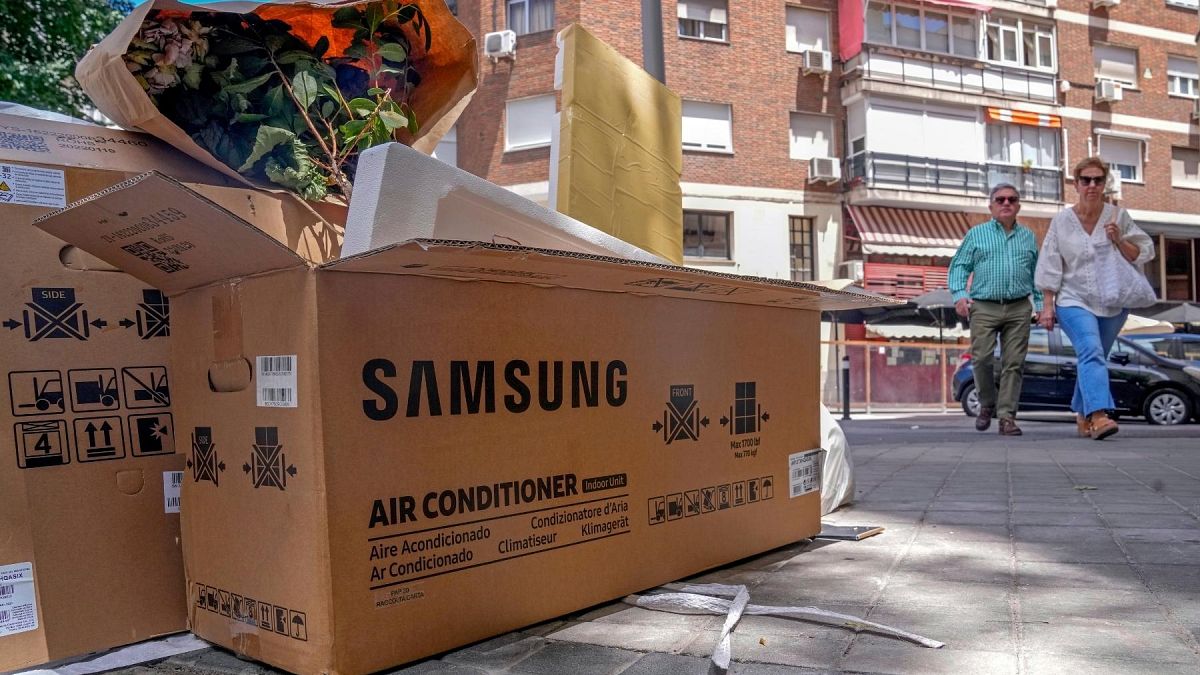 Empty air conditioner unit boxes lie on a street corner in Madrid, Spain, Sunday, 19 June, 2022. 