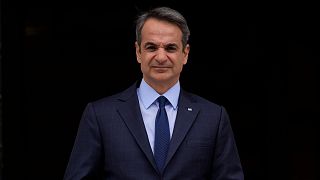 FILE - Greece's Prime Minister Kyriakos Mitsotakis stands outside Maximos Mansion in Athens, May 6, 2022.