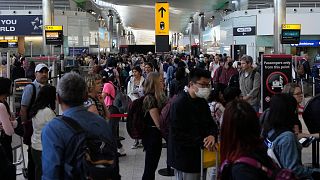 Travellers queue at security at Heathrow Airport in London, June 22, 2022.