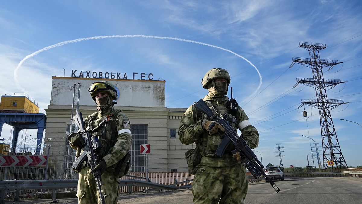 Russian troops guard an entrance of the Kakhovka Hydroelectric Station, a run-of-the-river power plant on the Dnieper River in Kherson region, southern Ukraine, May 20, 2022.