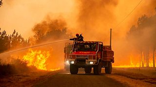 Firefighters tackling a blaze near Hostens, south of Bordeaux, southwestern France, Wednesday, Aug. 10, 2022.
