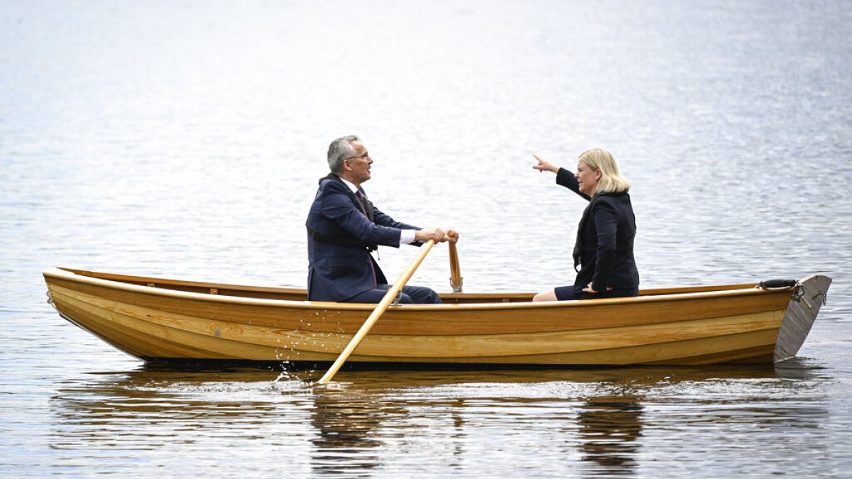Sweden's Prime Minister Magdalena Andersson, right, and NATO Secretary General Jens Stoltenberg talk on a traditional rowboat Monday, 13 June, 2022.