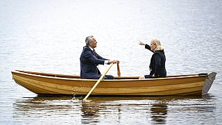 Sweden's Prime Minister Magdalena Andersson, right, and NATO Secretary General Jens Stoltenberg talk on a traditional rowboat Monday, 13 June, 2022.