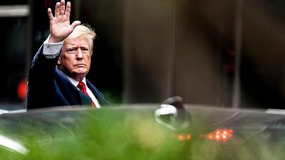 Former President Donald Trump waves as he departs Trump Tower, Wednesday, Aug. 10, 2022, in New York