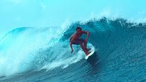 An extreme surfer rides a barrel wave in Teahupo'o