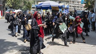 Taliban fighters fire in air to disperse Afghan women protesters in Kabul on August 13, 2022. 
