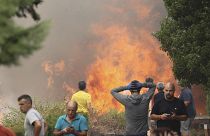 Neighbours stand near a forest fire in Anon de Moncayo, Spain on Aug. 13, 2022.