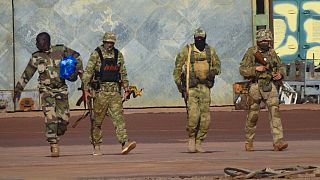 This undated photograph handed out by French military shows three Russian mercenaries, right, in northern Mali.