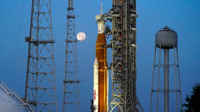 The Strawberry Supermoon sets in front of the NASA Artemis rocket with the Orion spacecraft aboard on pad 39B at the Kennedy Space Center, Wednesday, June 15, 2022