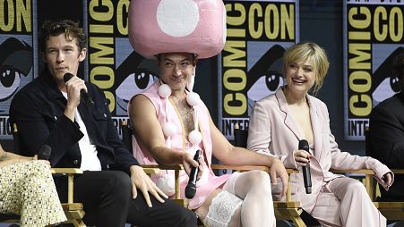 Ezra Miller, centre, dressed in a Toadette costume from the Super Mario Bros. video game franchise, attends Comic-Con International on Saturday, July 21, 2018