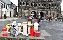 Candles and flowers are placed for the victims in Trier, western Germany, a day after a car was driven fatally into pedestrians, December 2, 2020.