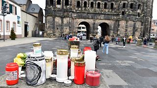 Candles and flowers are placed for the victims in Trier, western Germany, a day after a car was driven fatally into pedestrians, December 2, 2020.