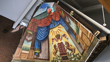 The mural painted in 1910 by a Lithuanian immigrant has been rehabilitated and moved and is what experts say is a rare piece of art.