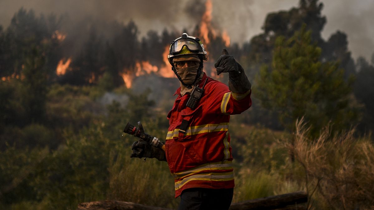 A firefighter works to combat a wildfire in Orjais, Covilha council in central Portugal, on August 16, 2022.