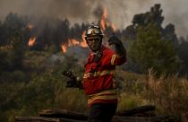 A firefighter works to combat a wildfire in Orjais, Covilha council in central Portugal, on August 16, 2022.