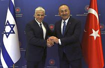 Turkish Foreign Minister Mevlut Cavusoglu, right, and Israeli Foreign Minister Yair Lapid pose for photos before their talks, in Ankara, Turkey, June 23, 2022.