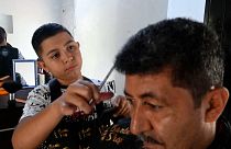 Eduardo Espinal, a 12-year-old barber.