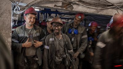 Miners emerge from the mine called Heroes of the Cosmos in Pavlograd city, in the Donbas region, east Ukraine, on August 15, 2022.