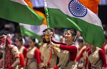 Assamese girls and boys in traditional attire carry Indian flags as they perform Bihu dance on Independence Day in Gauhati, northeastern Assam state, India, Aug. 15, 2022