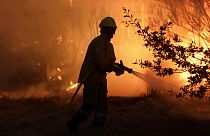 A firefighters works to stop a wildfire in Gouveia, in the Serra da Estrela mountain range, in Portugal on Thursday, Aug. 18, 2022. 