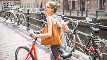 A woman with a bike in Amsterdam. The Netherlands has some of the highest rates of cycling in the world. 