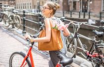 A woman with a bike in Amsterdam. The Netherlands has some of the highest rates of cycling in the world.
