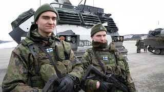 Finnish soldiers pose for a photo as NATO Secretary General Jens Stoltenberg visits during the Cold Response in Bardufoss, Norway, March 25, 2022.