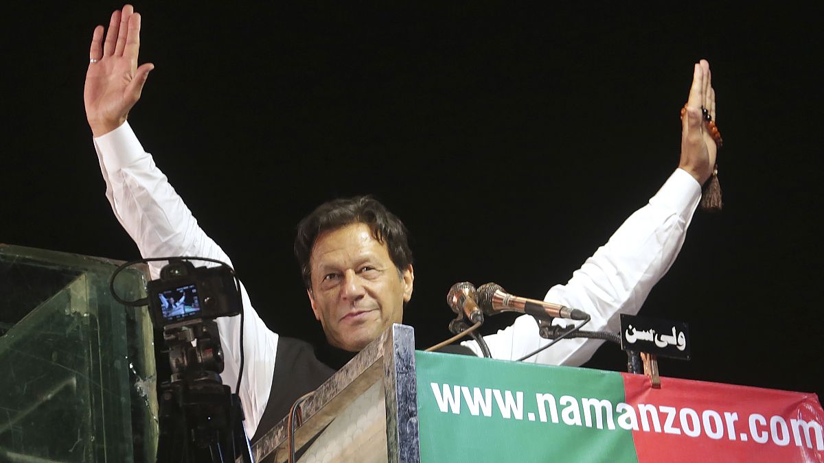 Former Pakistani Prime Minister Imran Khan waves to his supporters during an anti government rally, in Lahore, Pakistan, April 21, 2022.