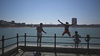 People cool off by the beach, following a long period of hot weather and little rain, in Margate, Britain.